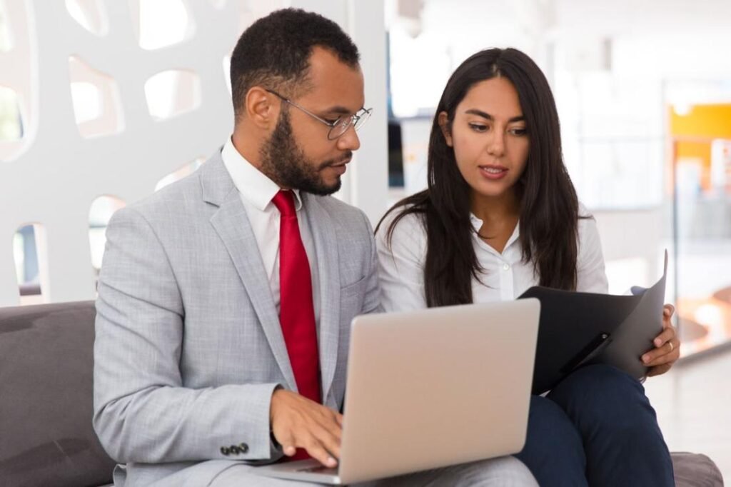 Auditor and client reviewing controls on a laptop